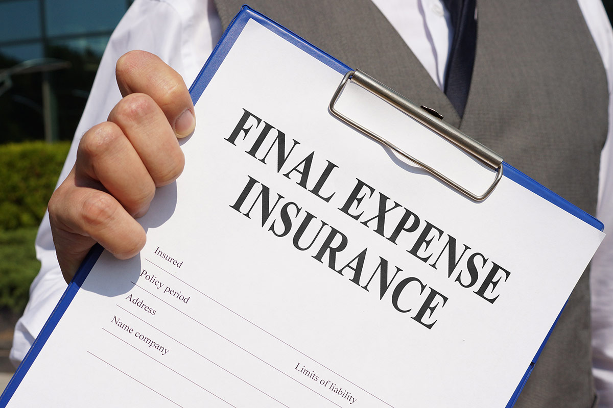 HedgeGuard Senior Benefits A person in a suit holds a clipboard with a document titled "senior insurance services" under the bright sun.